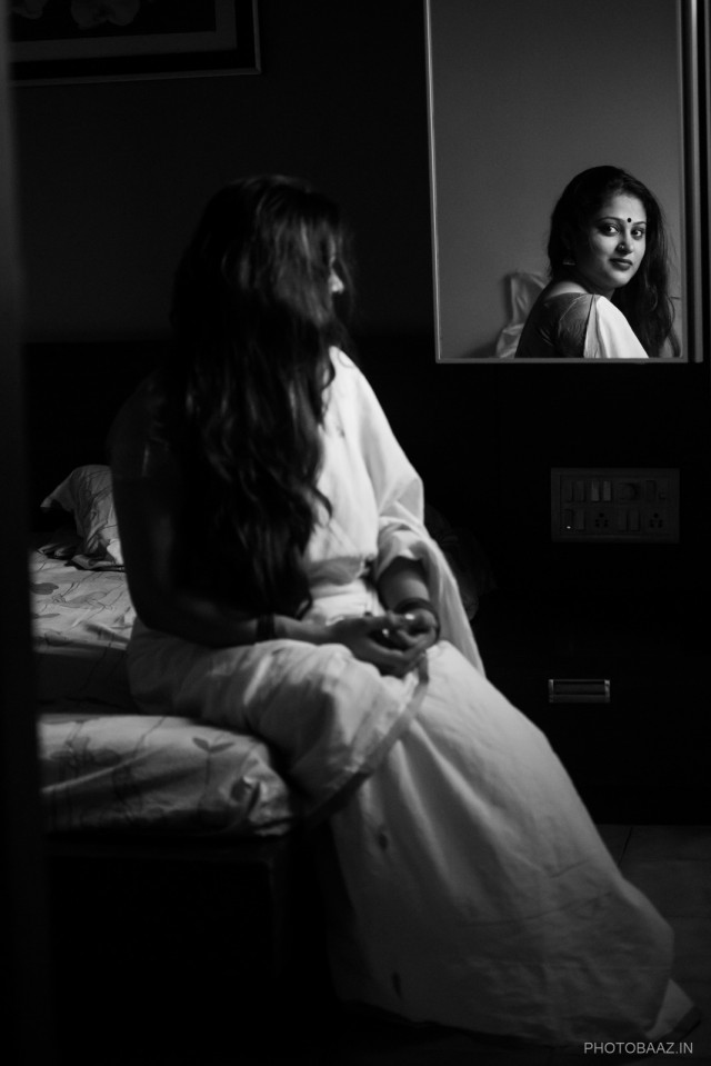 Shilpi Natasha Nath - traditional indian woman in a sari sitting before a mirror and being reflected